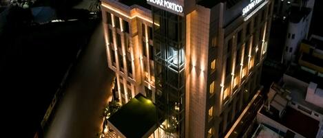A modern hotel with a prominent sign reading "Singhama Sarovar Portico."