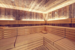 Uma sauna com bancos de madeira e teto inclinado.