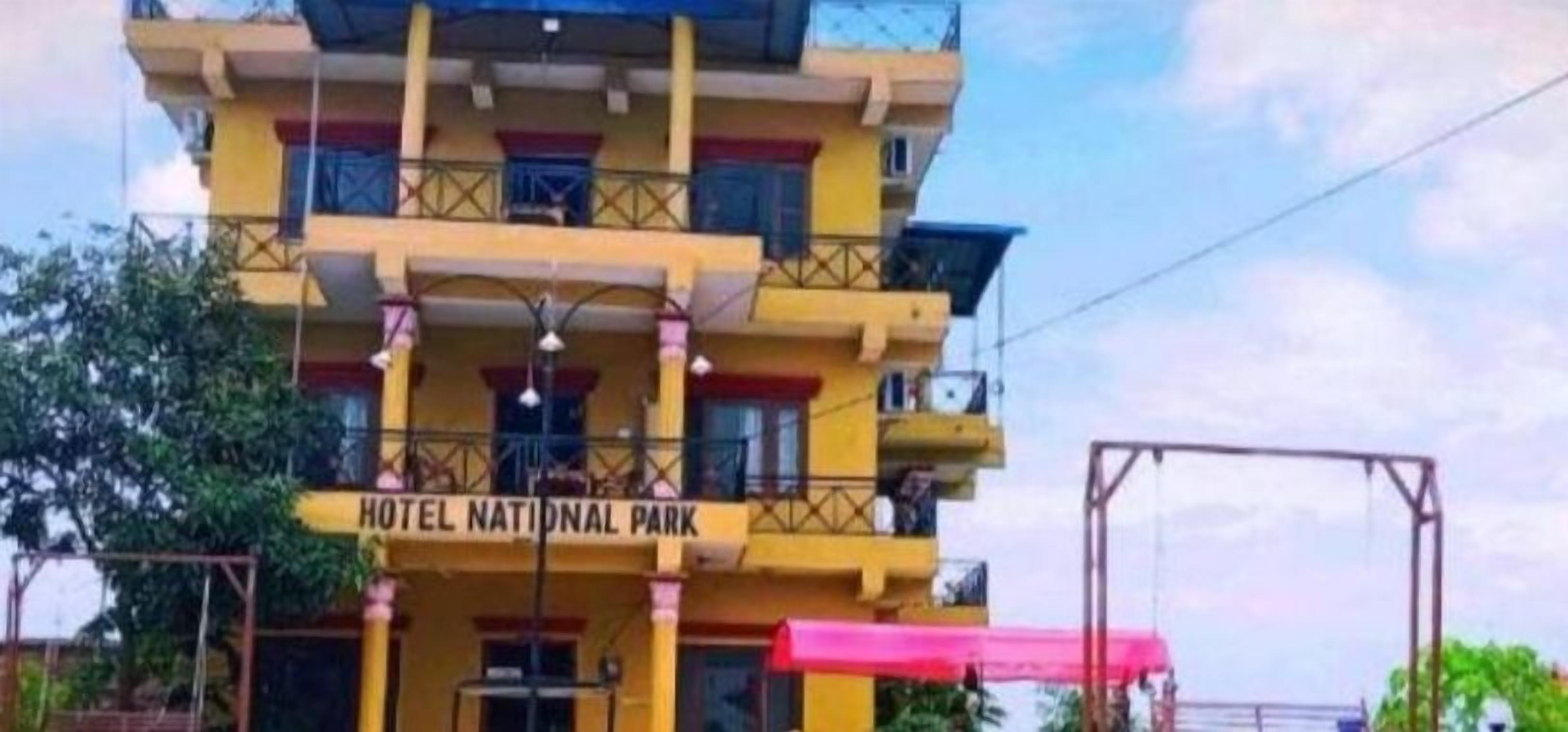 A multi-story building with balconies and a sign reading "HOTEL NATIONAL PARK".