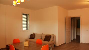 Deluxe Apartment, 2 Bedrooms | Living room | Flat-screen TV
