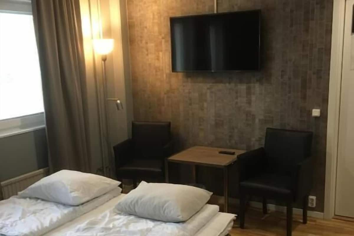 Deluxe Quadruple Room, Multiple Beds, Private Bathroom (1 single and 2 bunk beds) | Desk, laptop workspace, blackout drapes, iron/ironing board