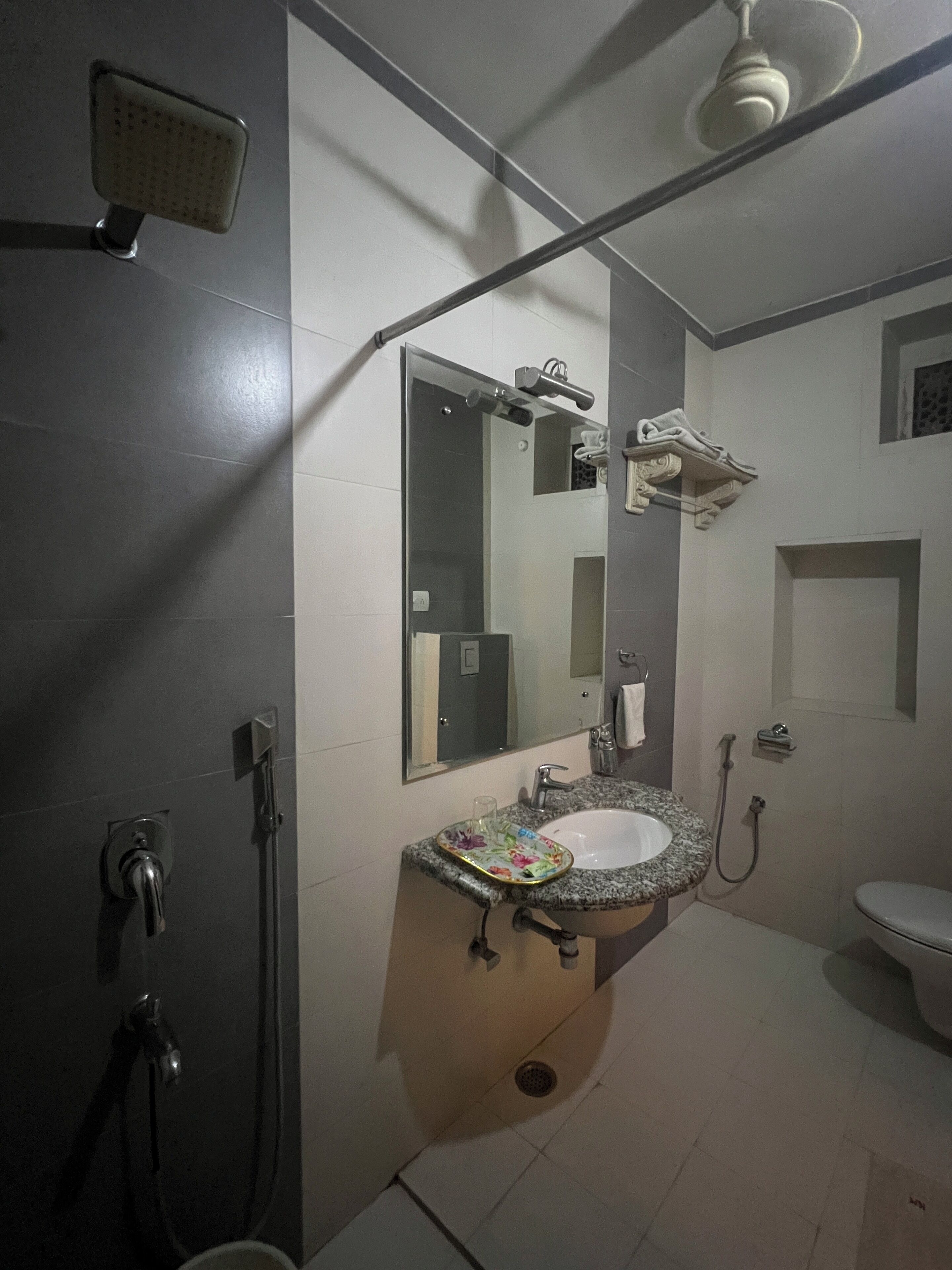 A bathroom with a shower, sink, and toilet.