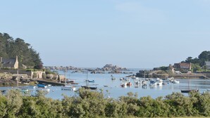 A coastal marina with boats docked, surrounded by rocky terrain and greenery. - T2 with open view on the port of Ploumanac'h, Perros-Guirec (Perros-Guirec)