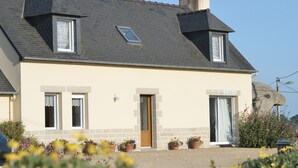 A two-story house with a sloped roof, a front door, and two windows. - T2 with open view on the port of Ploumanac'h, Perros-Guirec (Perros-Guirec)