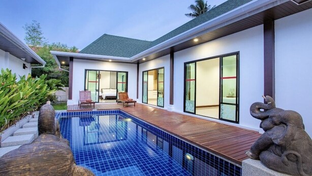 A modern house with a swimming pool, large windows, and a wooden deck. - Sanga Villas (Rawai)