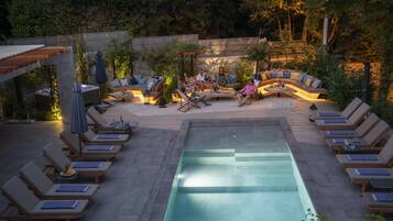 Outdoor pool, a waterfall pool, pool umbrellas, sun loungers