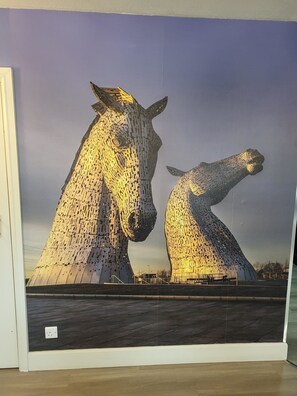 A large, illuminated sculpture of two horses.