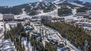 A snow-covered mountain town with a ski resort, including buildings and roads.