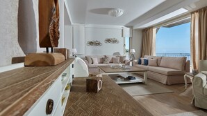 A modern living room with a sofa set, a coffee table, and a wooden accent wall. - Villa Omikron (Malevizi)