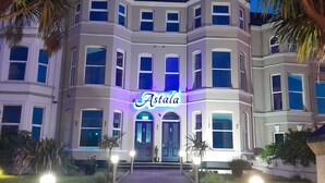 A large, multi-story building with a prominent "Astala" sign in the center. - Astala Guesthouse (Bangor)