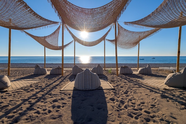 On the beach, black sand, free beach shuttle, sun loungers