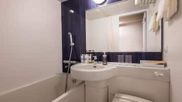 A bathroom with a white sink, a mirror, and a shower.