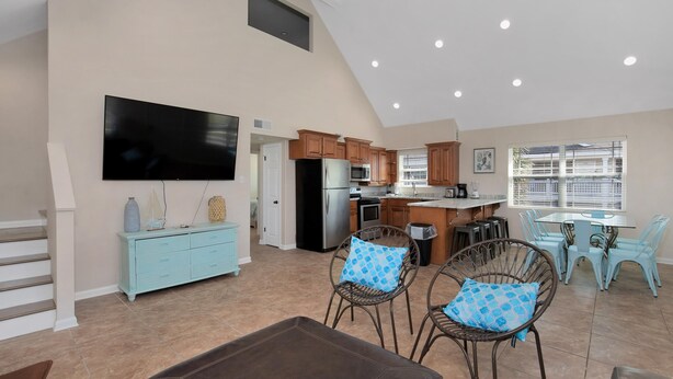 A spacious living area with a kitchen, dining table, and seating. - Prime Beach/Lagoon Location!  Walk to beach and restaurants! (Gulf Shores)