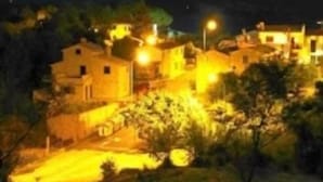 A village with traditional architecture, narrow streets, and warm lighting. - La Biocca (Manciano)