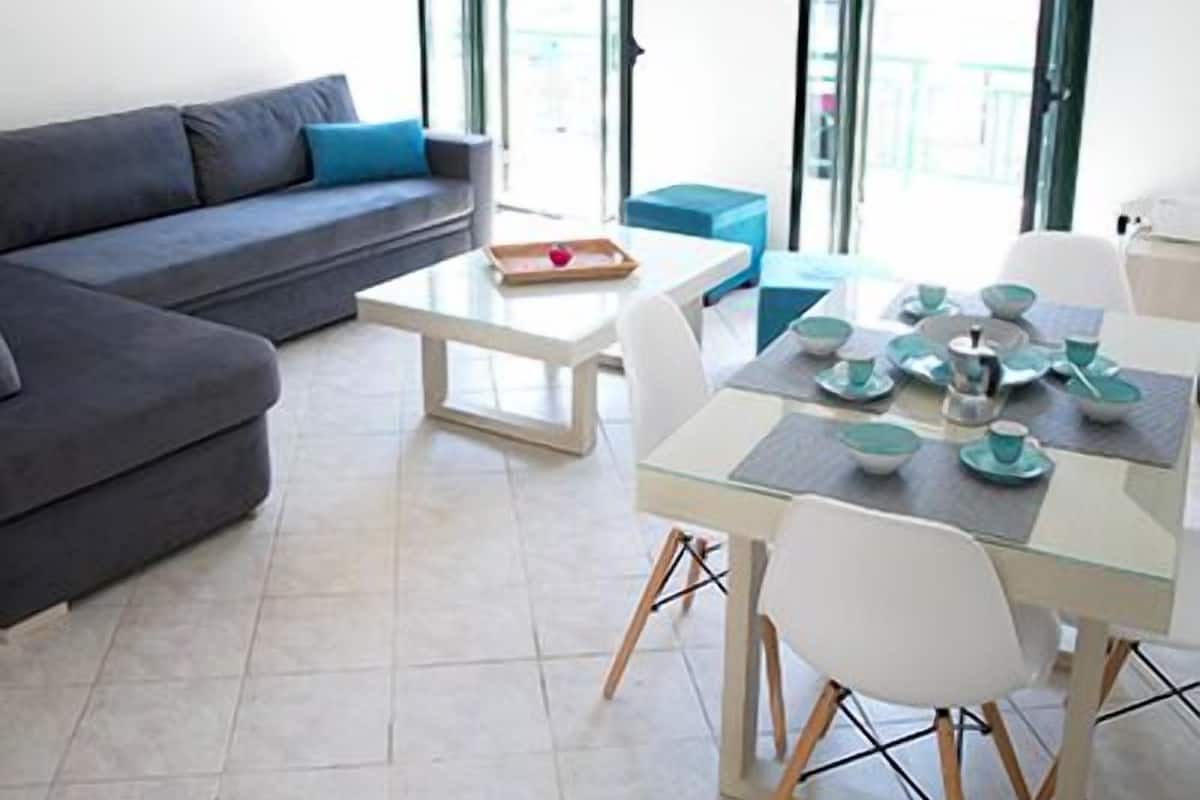Deluxe Apartment, 1 Bedroom, Balcony, City View | Living area | Flat-screen TV