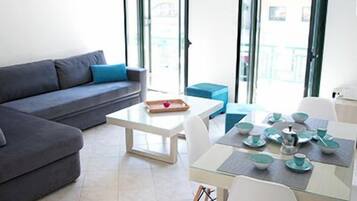 Deluxe Apartment, 1 Bedroom, Balcony, City View | Living area | Flat-screen TV