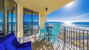 A balcony with a table and chairs, overlooking the ocean. - Phoenix 4 4031 Beachfront (Orange Beach)