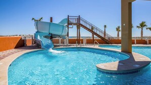A swimming pool with a water slide and a staircase leading to a higher level. - Phoenix Gulf Shores 803 (Gulf Shores)