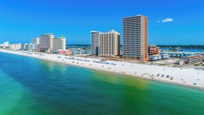 A coastal cityscape with high-rise buildings, a beach, and clear blue skies. - Phoenix Gulf Shores 803 (Gulf Shores)