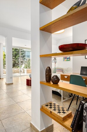 A modern interior with a wooden desk, a chessboard, and a laptop.