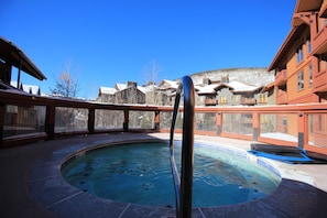 A hot tub with a clear view of surrounding buildings and a snowy landscape. - Copper One 4th Floor—New Carpet, New Furniture, 2 King Beds (Copper Mountain)