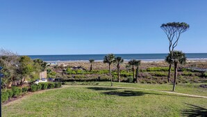 A grassy area with a clear view of the beach and ocean. - 301 Ocean One - 4 Bedroom Oceanfront Condo (Hilton Head Island)