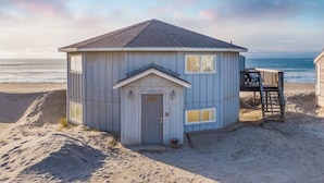 A beach house with a small porch and a door labeled "34320".