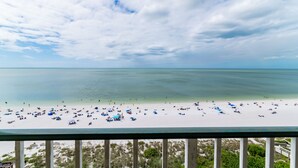 A beach with a clear view of the ocean and a balcony overlooking the beach. - Beachfront Penthouse at the Apollo!  Best Views on Marco Island! (Marco Island)