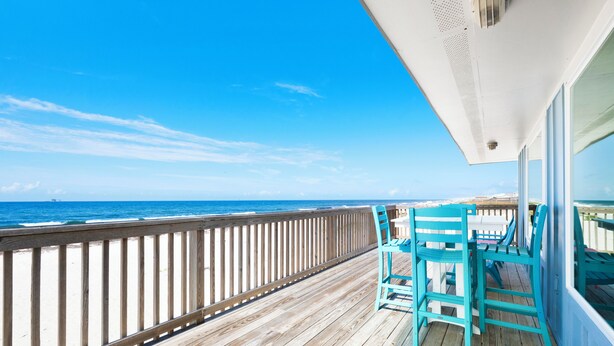 A wooden deck with a railing, overlooking the ocean. - Gulf Front | Pet Friendly | Shared Heated Pool (Gulf Shores)