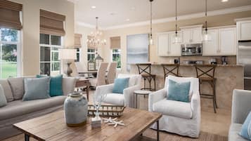 Relax in this inviting living space with a comfortable sofa, dining area, and modern kitchen.
