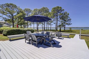 Enjoy dining al fresco on the deck surrounded by lush greenery and scenic views.