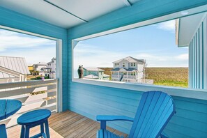 A balcony with blue chairs and a view of houses. - Upscale home! Beach Access! Community Pool (Port Aransas)