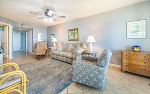 A living room with a sofa, armchair, and a wooden dresser. - Phoenix VII Condo on the 2nd Floor!!! One Bedroom (Orange Beach)