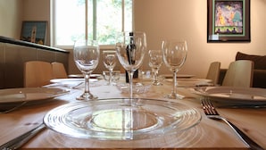 A dining table set with clear glassware and plates, a fork, and a knife. - Racer Five ~ Fantastic Family Home Close to Town, River and Wineries (Guerneville)
