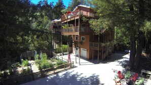 A multi-story building with a balcony, surrounded by trees. - Racer Five ~ Fantastic Family Home Close to Town, River and Wineries (Guerneville)