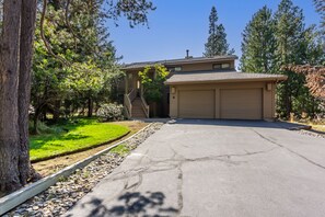 A residential property with a garage, a driveway, and a well-maintained lawn.