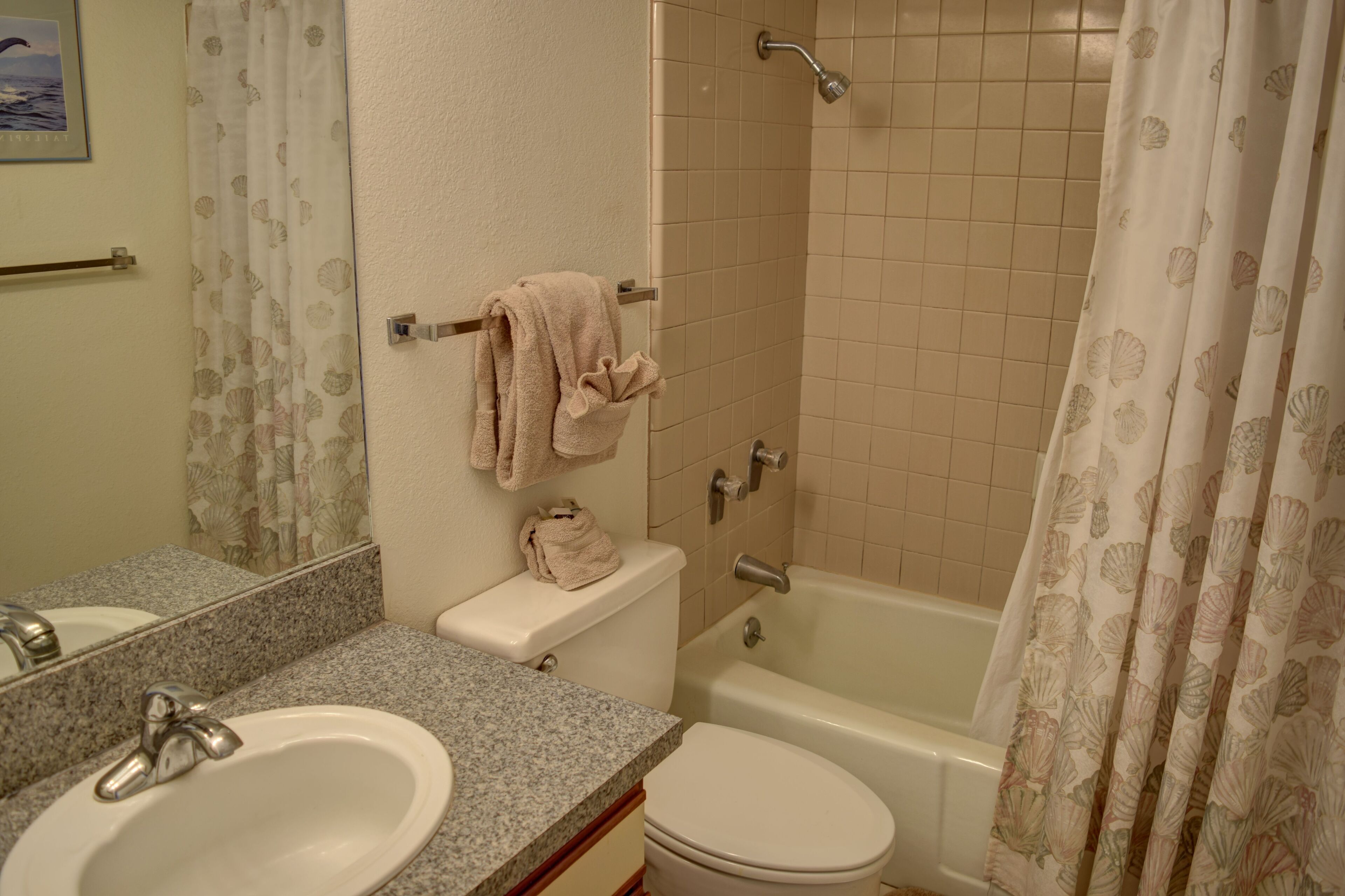 A bathroom with a sink, toilet, and bathtub.