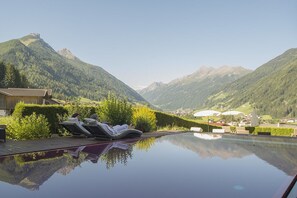 Outdoor pool, an infinity pool, pool loungers