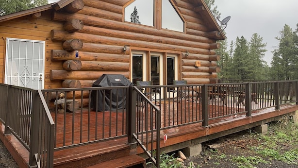 A log cabin with a deck, a grill, and a satellite dish. - Hurd Cozy Log  Cabin (Greer)