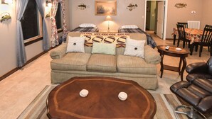 A cozy living room with a sofa set, a coffee table, and a dining area with chairs and a table.
