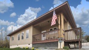 A two-story house with a balcony and an American flag.