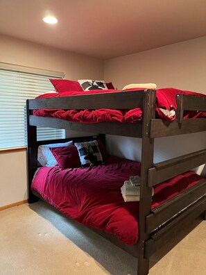 A bunk bed with red bedding, a window with blinds, and a ceiling light. - Come Play In The Mountains, Hot Tub, Fenced, (South Lake Tahoe)