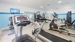 A gym with treadmills, ellipticals, and weight machines. - Coastal Sanctuary: Resort Condo Featuring Oasis Pool and Vibrant Tiki Bar (Pensacola)