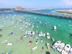 Boats docked in the marina, surrounded by calm waters and a scenic pier.