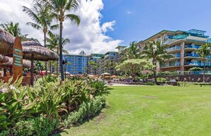 Escape to a tranquil oasis with lush gardens and a modern hotel building.
