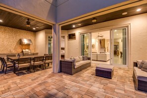 Enjoy a stylish dining and seating area with an oven and stainless steel range hood.