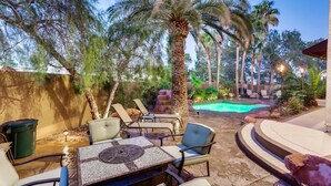 An outdoor patio area with a pool, lounge chairs, and a table. - 5 STAR ⭐️⭐️⭐️⭐️⭐️ STUNNING PRIVATE LV ESTATE! (Las Vegas)