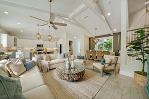 Relax in this inviting living area with a large round coffee table and comfortable seating.