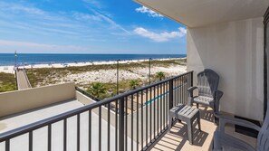 A balcony with a view of a beach and ocean.