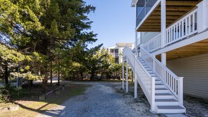 A gravel path leading to a building with a white staircase and a covered balcony. - Close to the Beach, Pet Friendly/Tesla Charger/2-3 Night Stays Off Season (Milton)